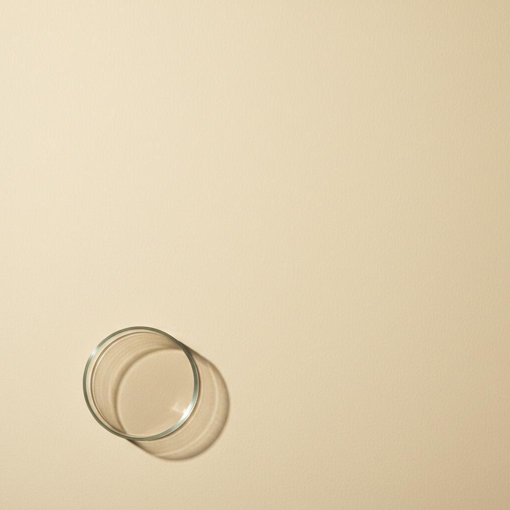 An empty glass petri dish on a pale cream surface — a stand-in for how little human evidence exists for epitalon.